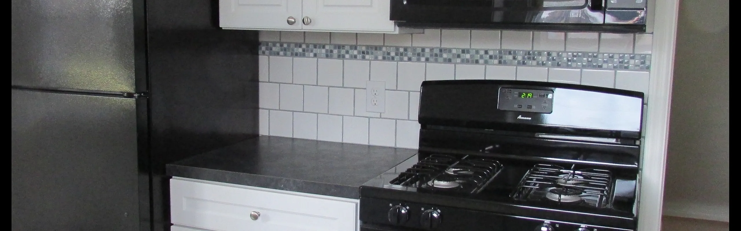 Renovated kitchen with stainless steel appliances at Adams Park Apartments in Albany, NY