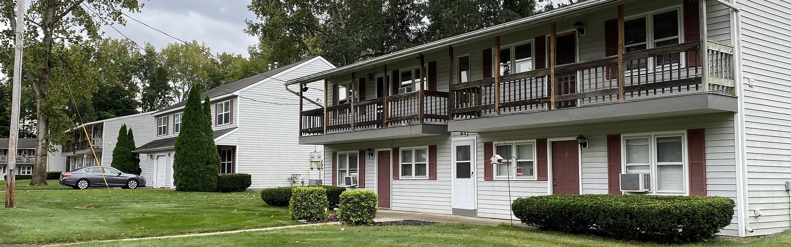 Apartment homes framed by mature trees at Halfmoon Garden Apartments in Clifton Park, NY