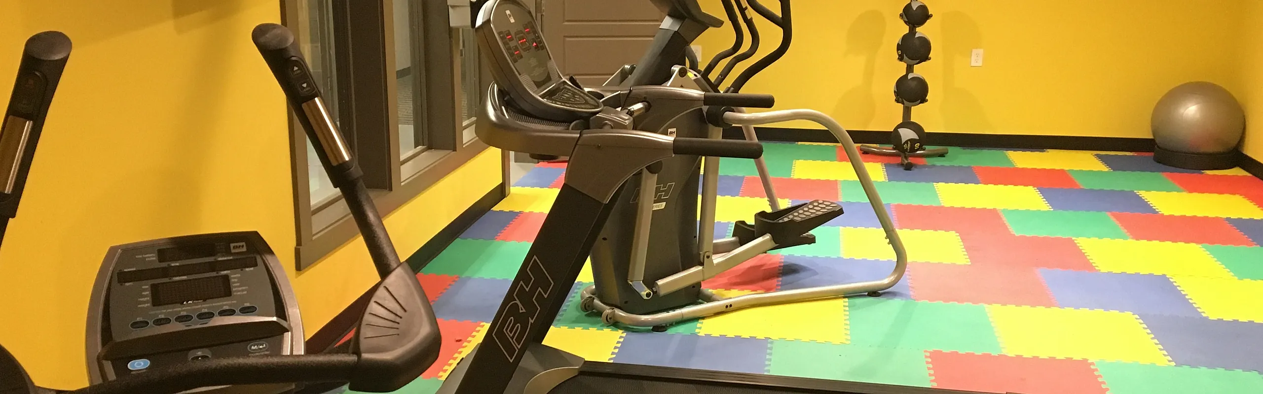 Fitness center with cardio equipment at Homeroom Lofts in Averill Park, NY