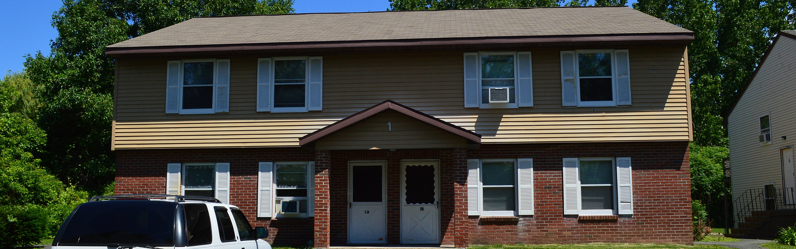 Two-story brick townhome exterior at Pine Park Terrace in Waterford, NY