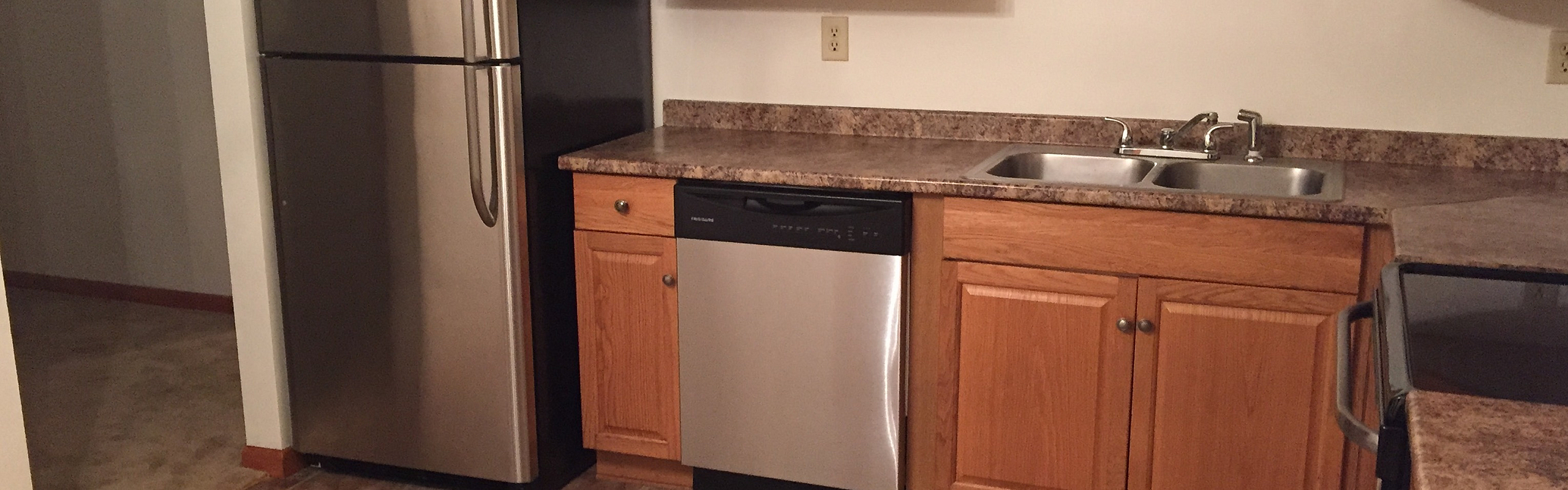 Apartment kitchen with dishwasher and wood cabinetry at Pine Park Terrace in Waterford, NY