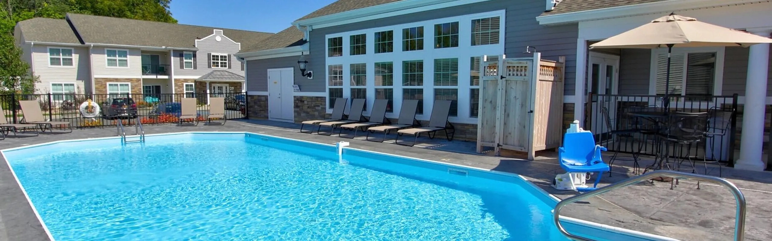 Outdoor pool and sun deck beside the clubhouse at Van Allen Apartments in North Greenbush, NY