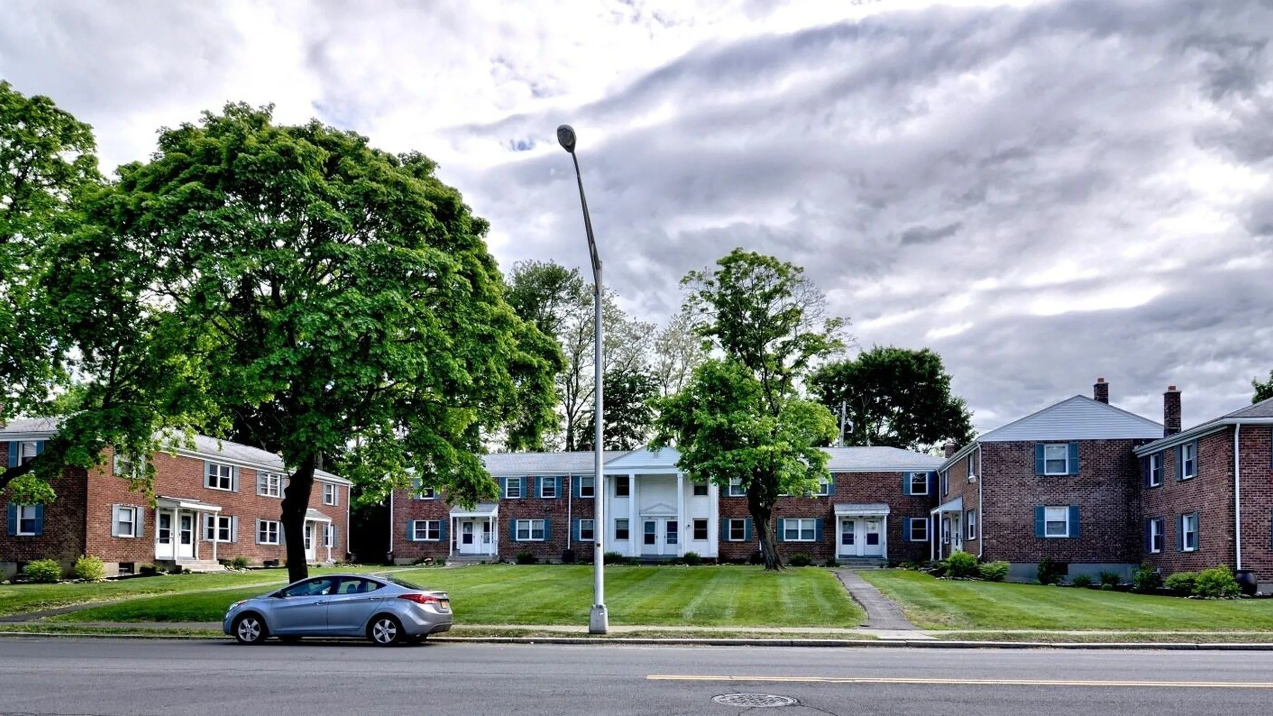 Courtyard between brick townhomes at Adams Park Apartments