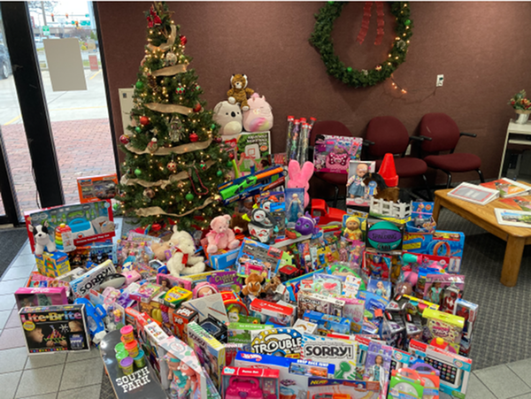 Christmas tree with a big pile of donated toys