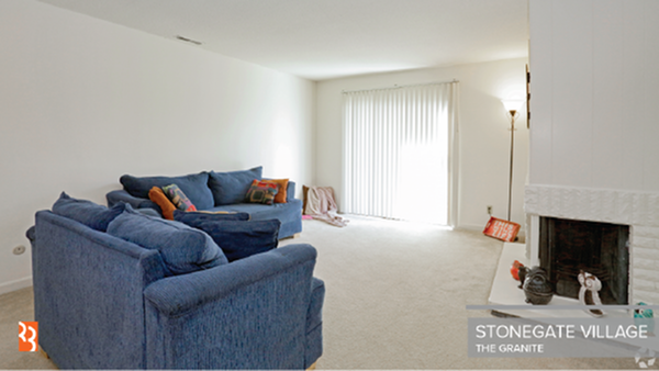 carpeted living room with a fire place