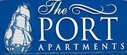 Distinctive The Port Apartments sign with nautical theme featuring a classic ship silhouette, ideal for seaside living.