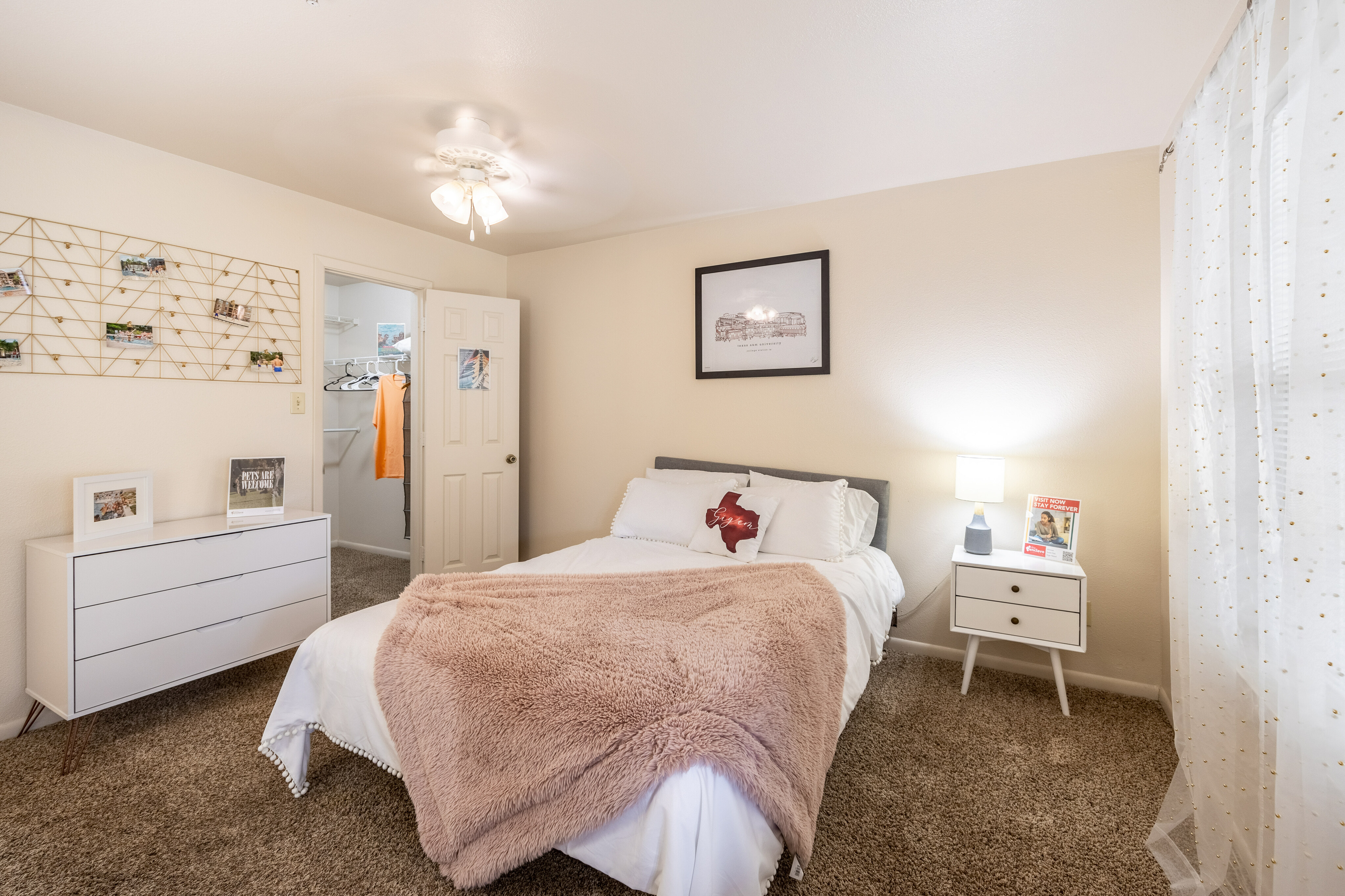 Inviting bedroom with plush carpet, soft lighting, and stylish decor.
