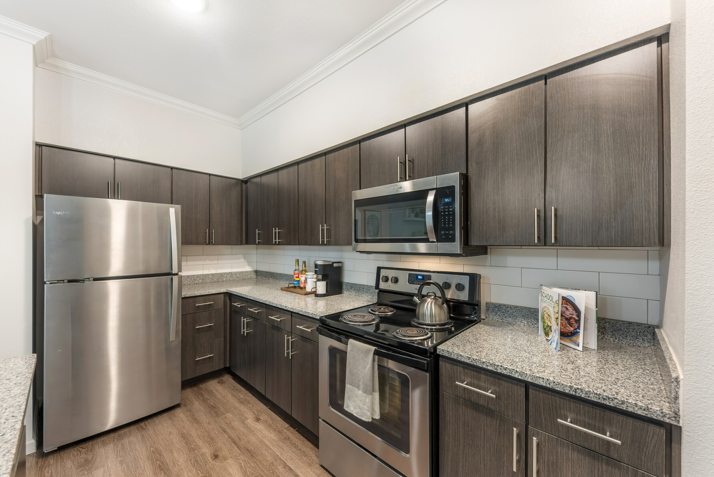 Granite Countertop Kitchen at Stone Hill Apartments in Pflugerville, TX