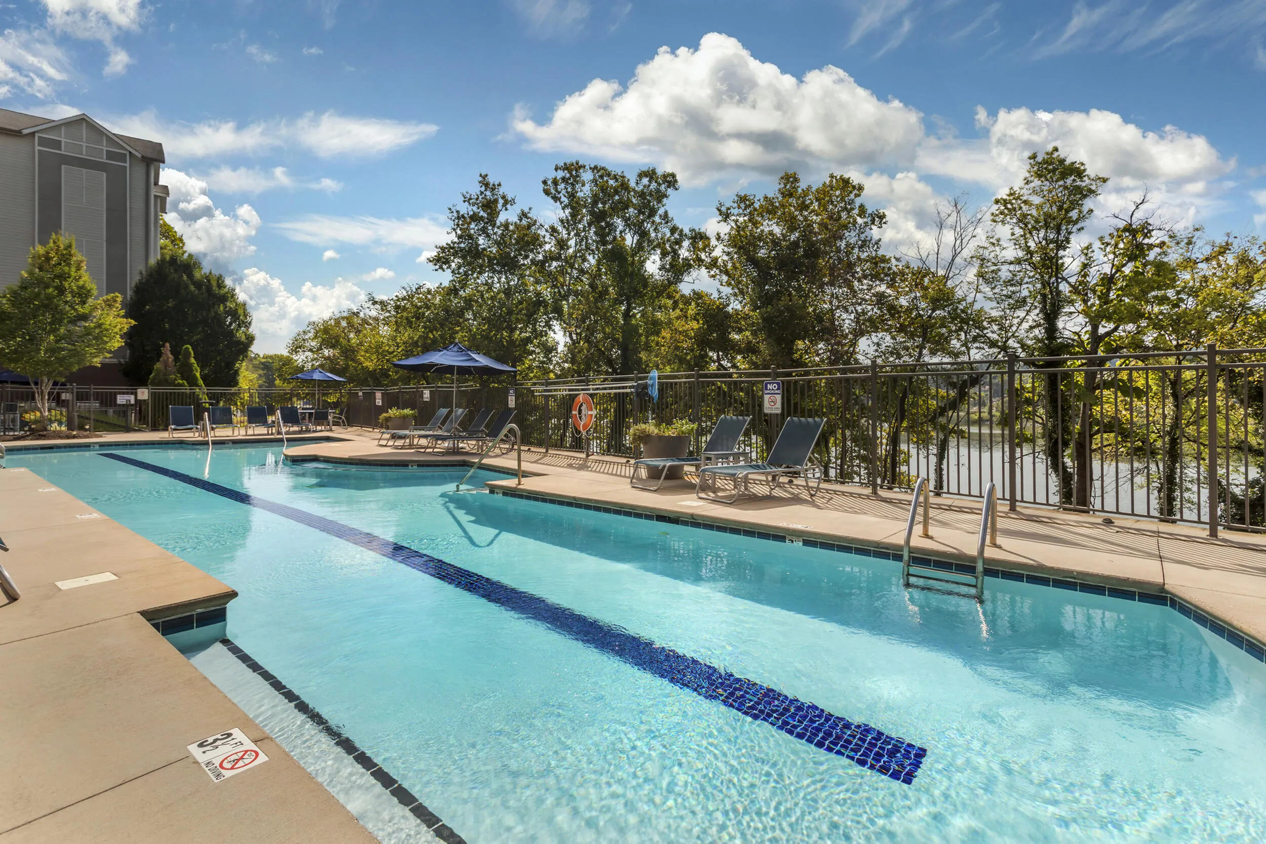 Sparkling outdoor saltwater pool with lounge area at The Landings riverside apartments Knoxville TN