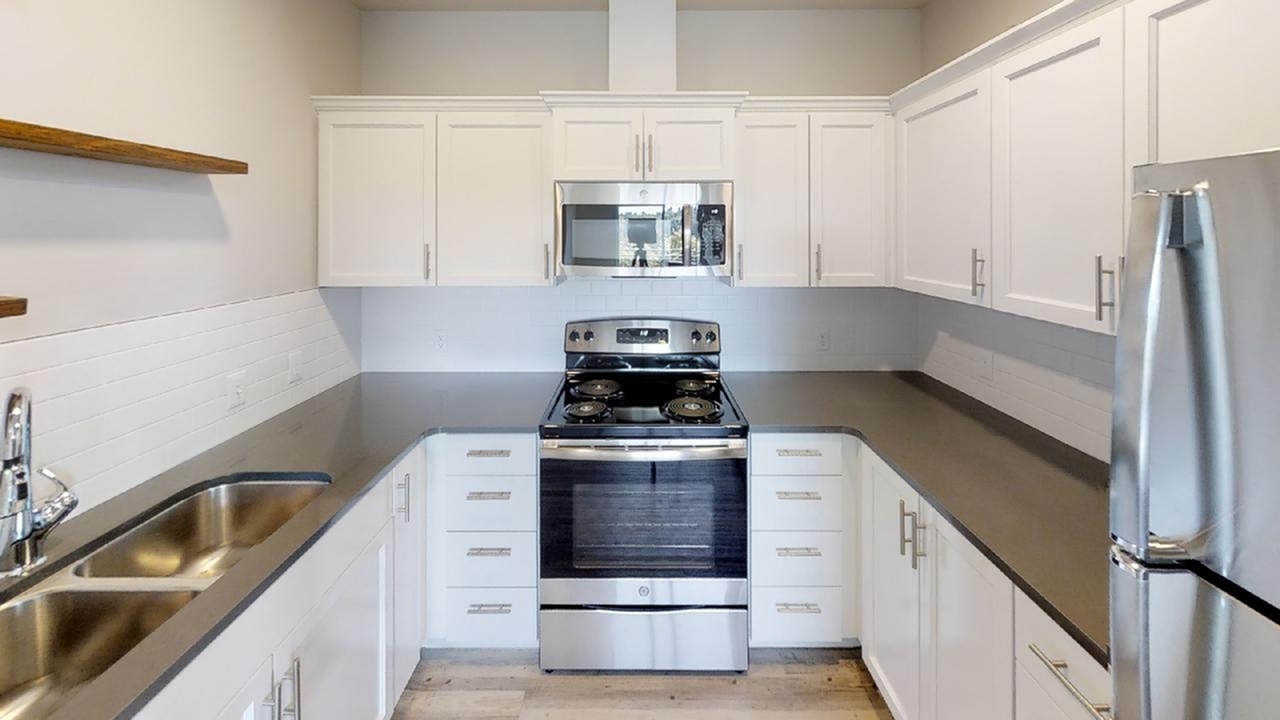 Kitchen with stainless steel appliances in a 3-bedroom loft at The 446 student apartments near WSU Pullman WA