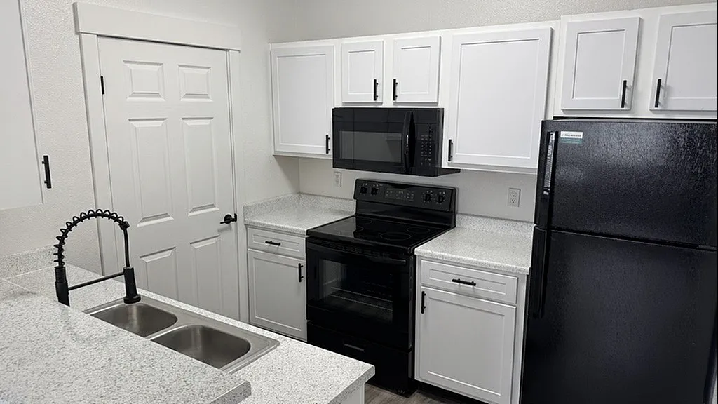 Noir package black-on-black GE Energy Star appliances at Pinnacle Mountain View apartments in Clearfield, UT