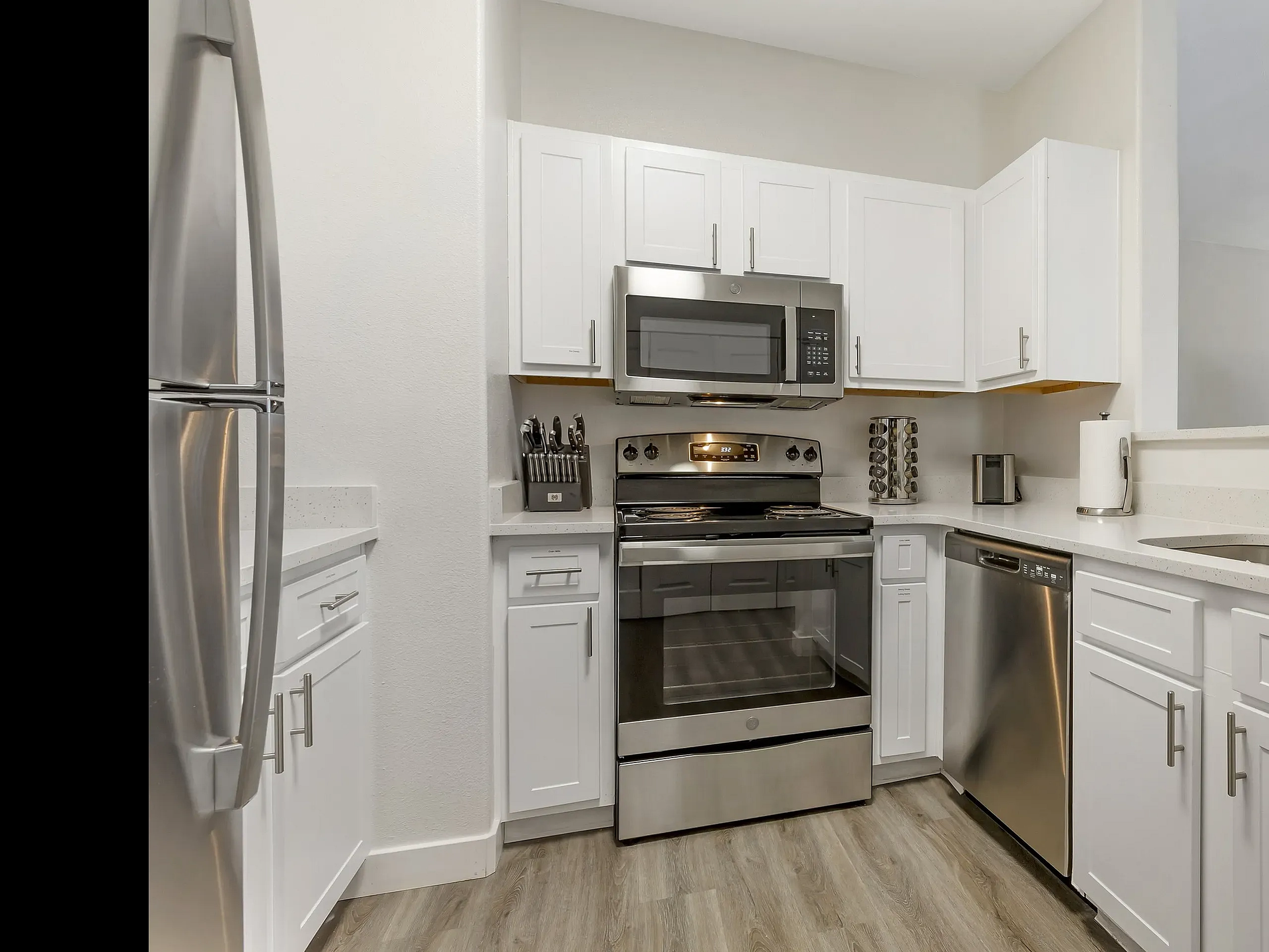 Stainless steel appliances in a Pinnacle Mountain View apartment kitchen in Clearfield, UT