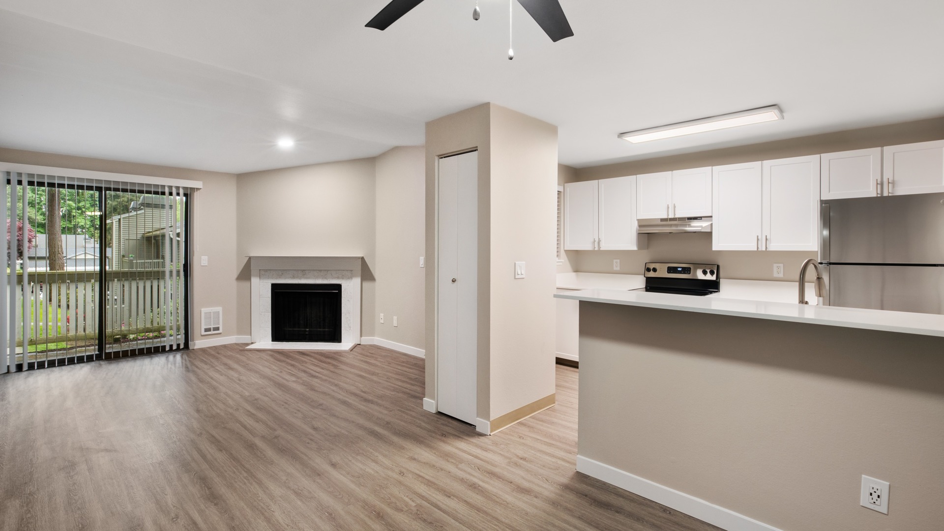 Open floor plan apartment interior with kitchen and living area at Totem Lake Heights in Kirkland, Washington