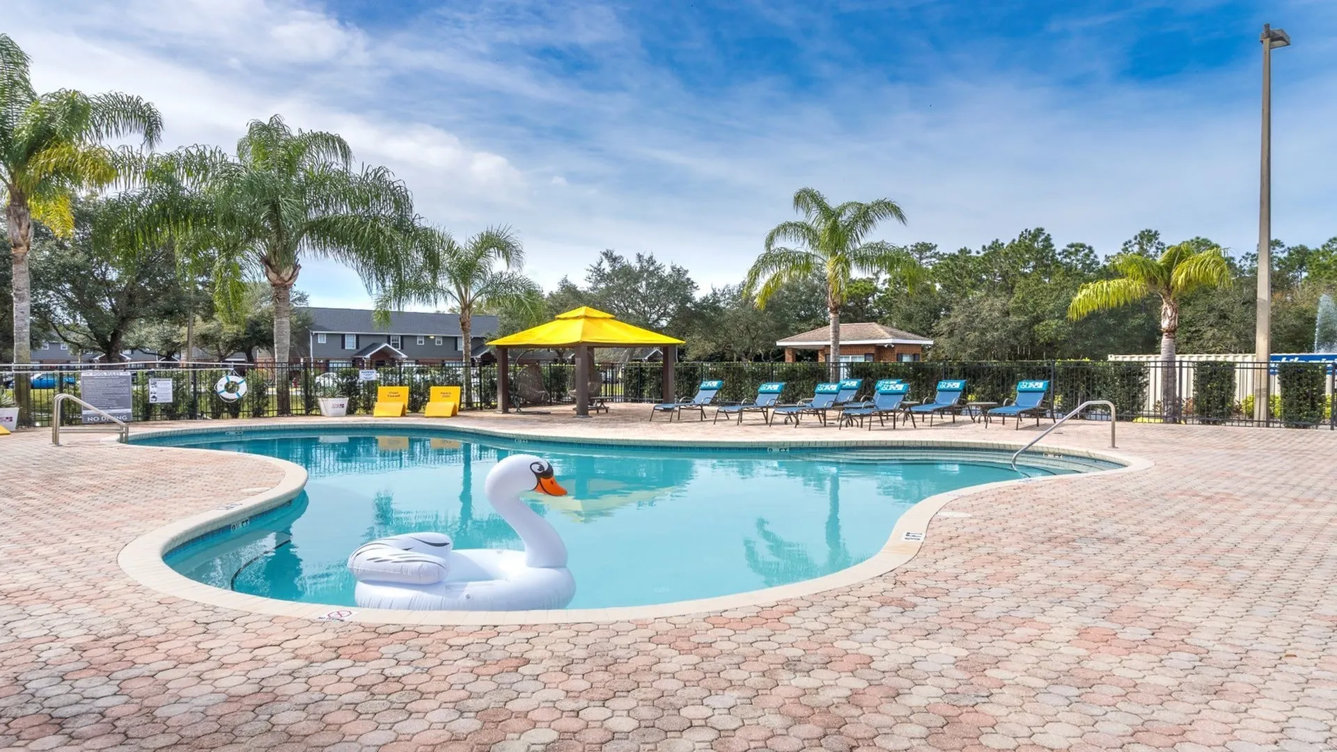 The Quad resort-style pool with lounge seating and surrounded by natural landscape.