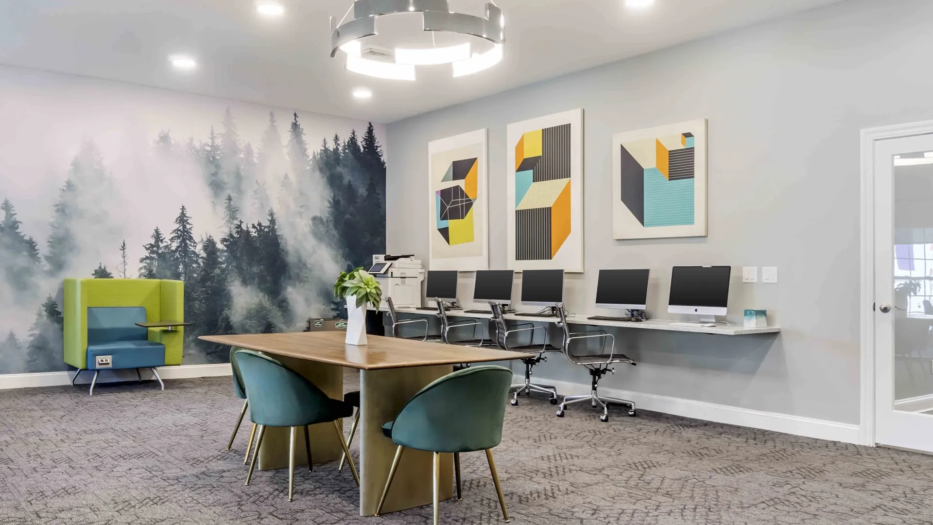 Computer lab with forest mural at The Verge student apartments in Ellensburg, Washington