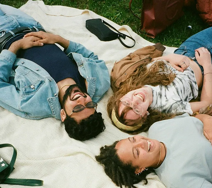Group of college students relaxing and socializing together representing student lifestyle at Campus Circle Urbana IL
