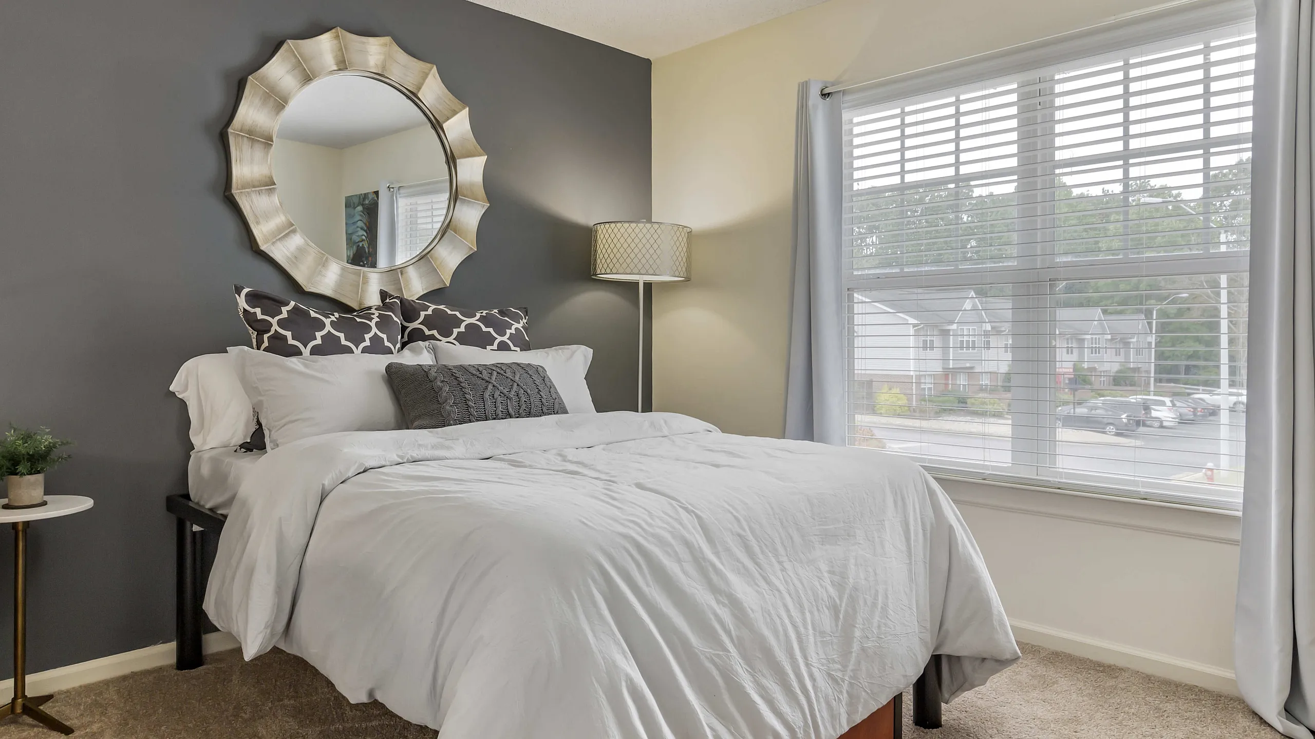 Bright bedroom with modern furnishings at University Suites student apartments in Raleigh NC