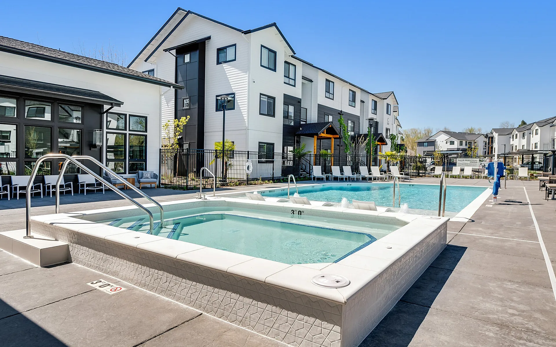 Resort-style swimming pool and spa with apartment buildings at The Preserve on Goodpasture Eugene Oregon