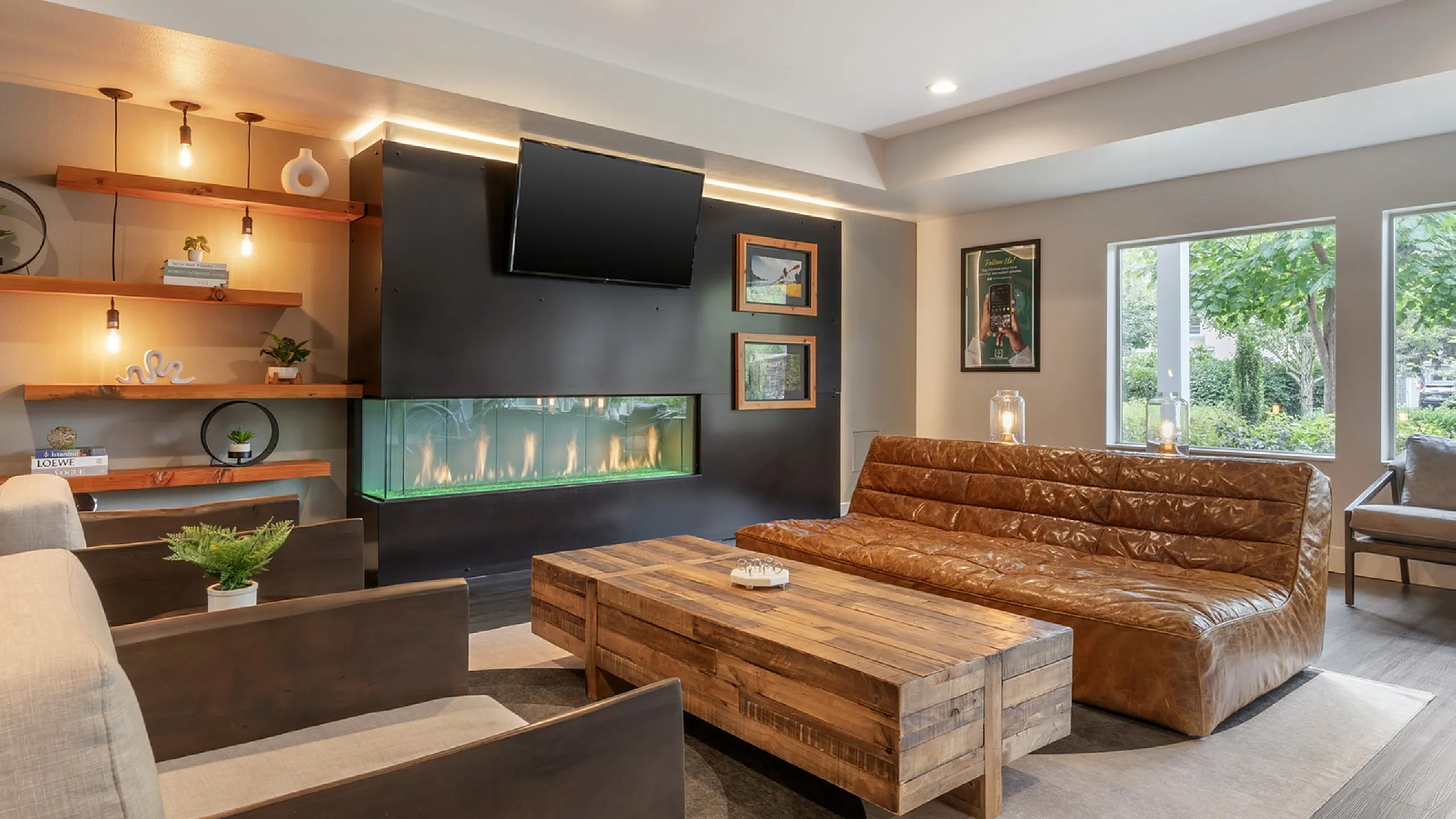 Inviting living room with elegant modern design featuring a cozy leather sofa, sleek wooden coffee table, ambient lighting, and a stylish built-in fireplace.