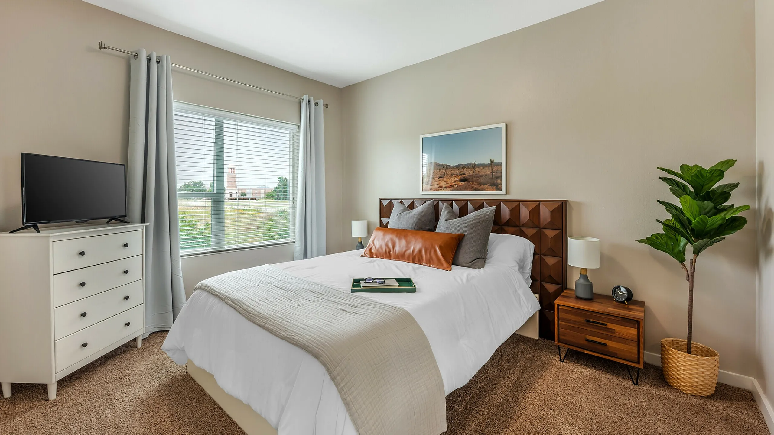 Spacious bedroom with large window and stylish decor at The View at Cedar Park luxury apartments in Cedar Park, TX