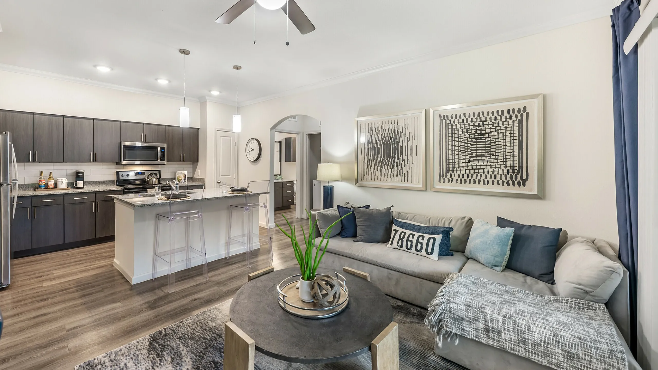 Contemporary open-concept apartment living room and kitchen at Stone Hill in Pflugerville, TX