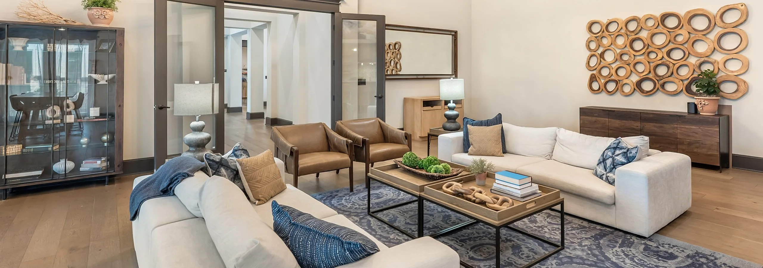 Elegant living room with plush sofas, contemporary decor, and modern lighting at Stone Hill Apartments in Pflugerville, TX