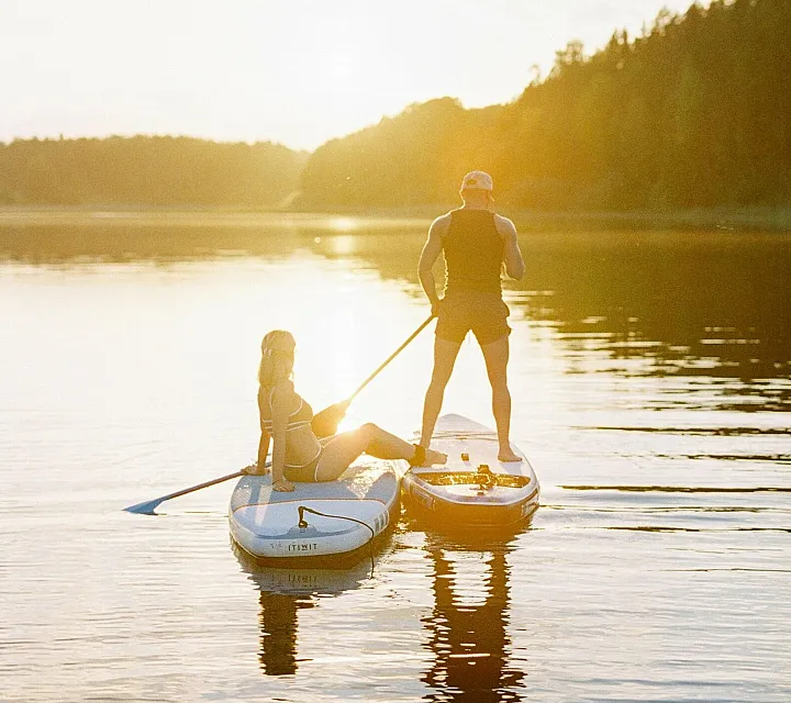 Paddleboarding on scenic lake representing the outdoor adventure lifestyle near The Current apartments in Bend, OR