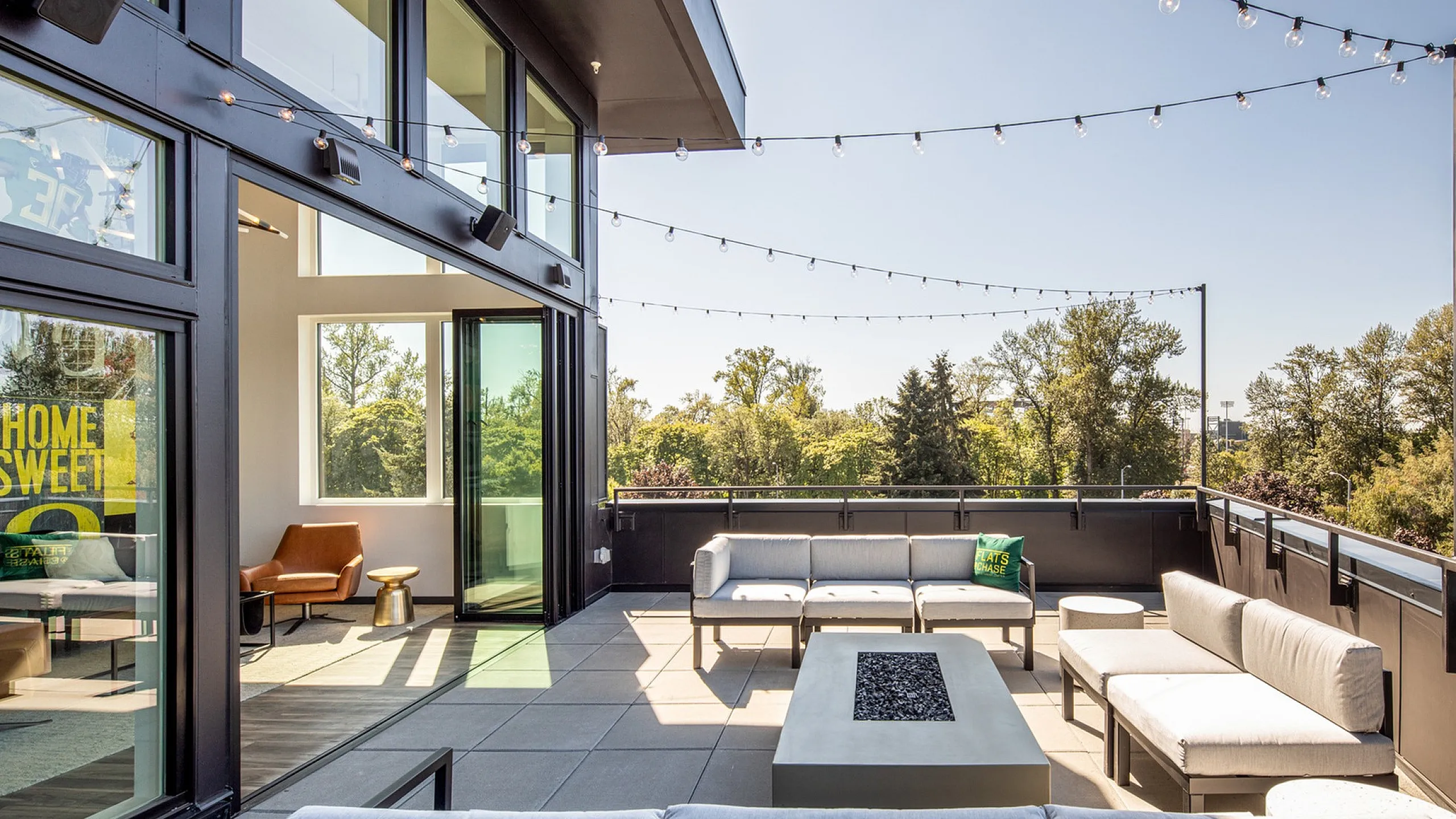 Apartment Balcony with Outdoor Seating and String Lights at The Flats at Chase Student Apartments in Eugene, OR