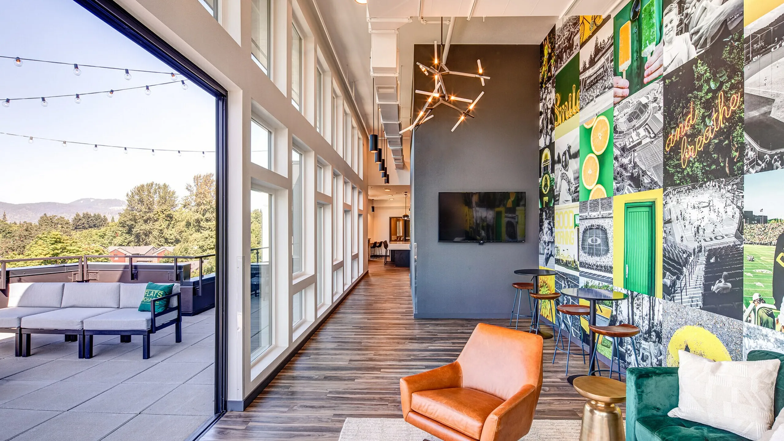 Modern Apartment Lounge with Accent Wall and Balcony Views at The Flats at Chase Student Apartments in Eugene, OR