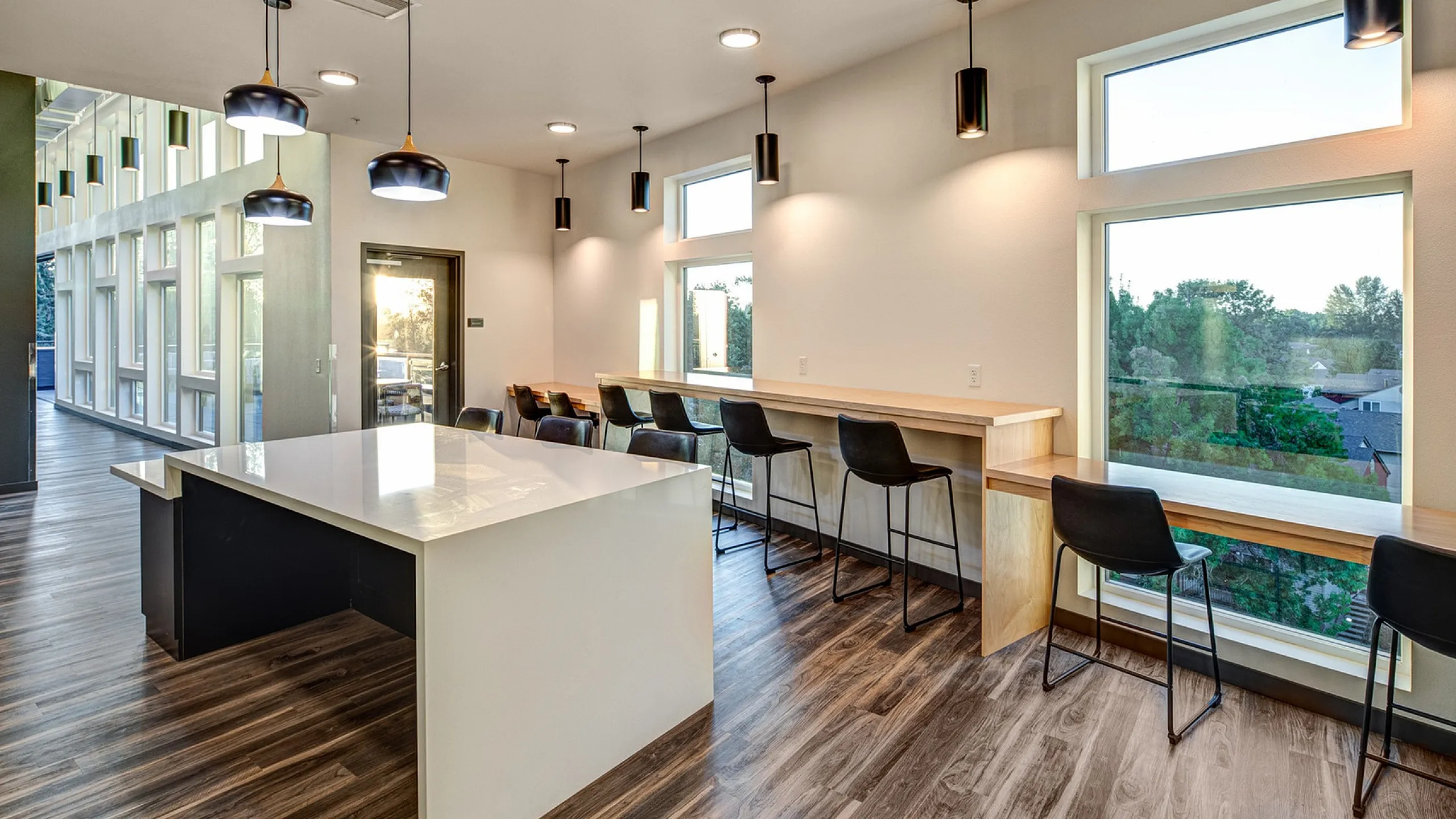 Community Common Area with Kitchen Island and Pendant Lighting at The Flats at Chase Student Apartments in Eugene, OR