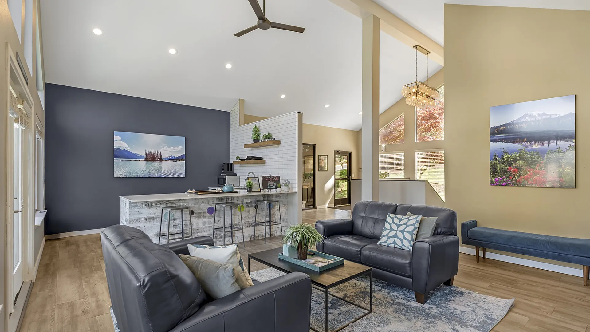 Canyon Springs apartment living room with open layout sleek leather sofas kitchen bar and large windows in Lynnwood WA