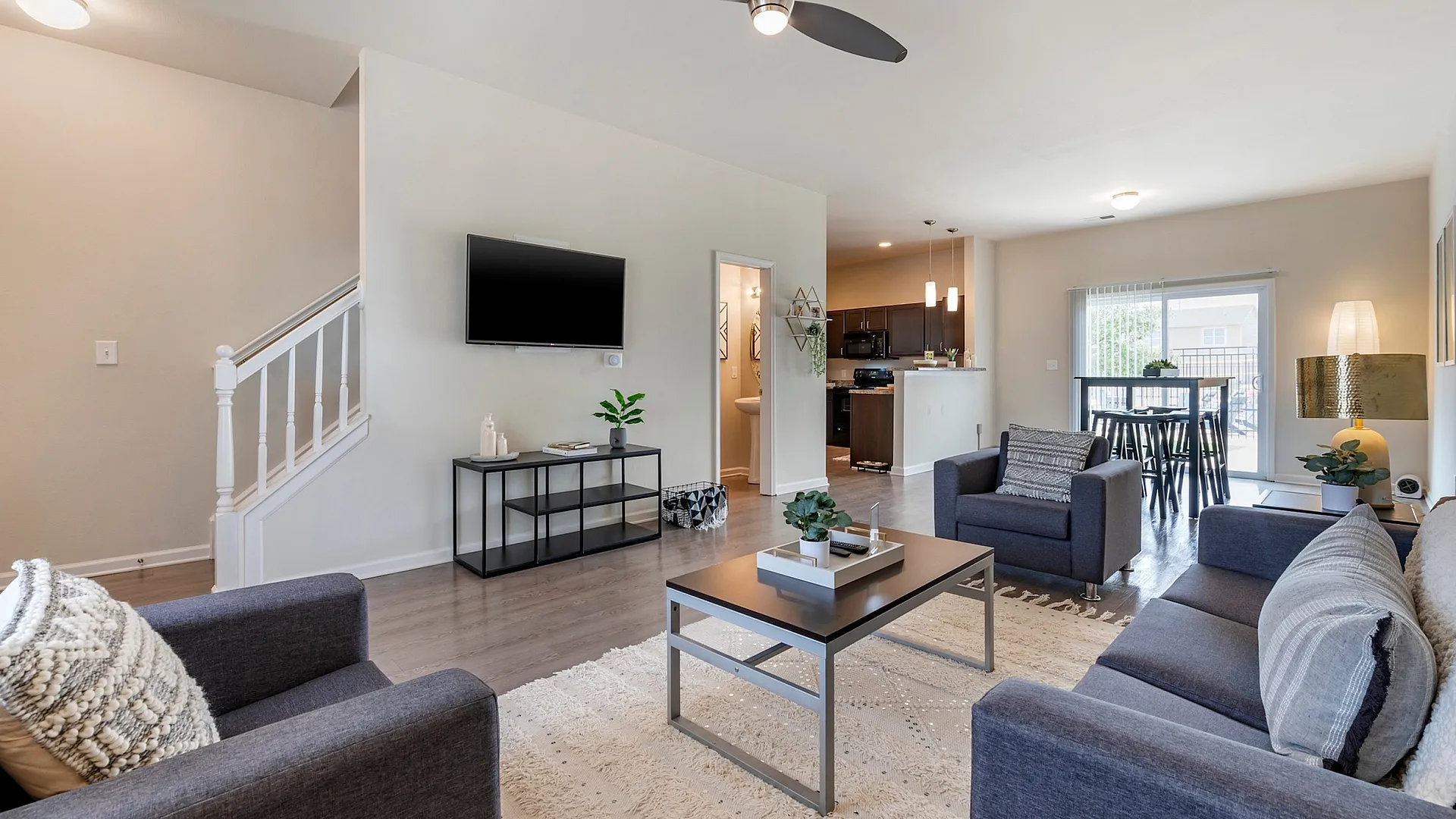 Elegant open-concept living room with modern furnishings and natural light at The Cottages on Lindberg in West Lafayette, IN