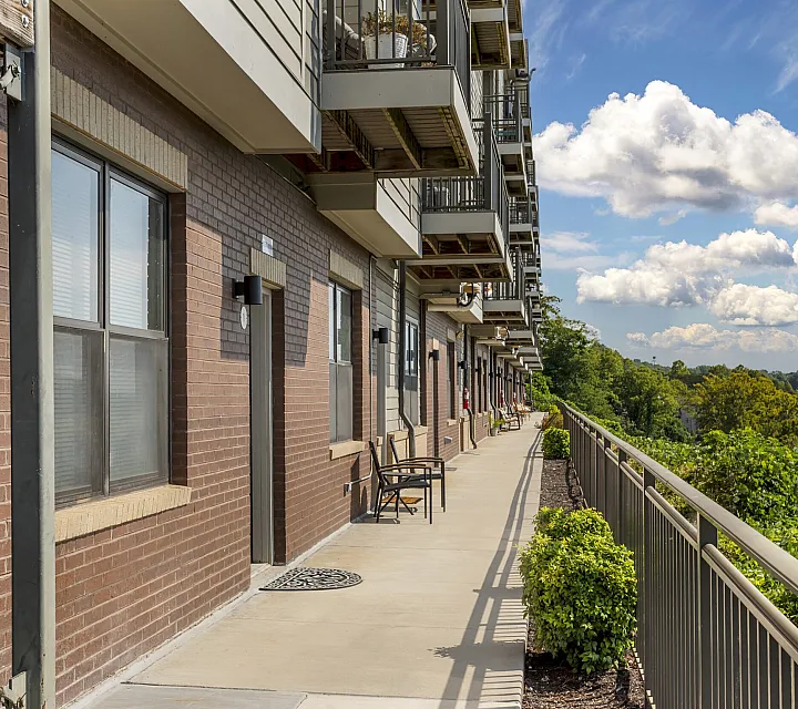 Elegant brick exterior of The Landings riverside apartment community with private balconies and lush landscaping Knoxville TN
