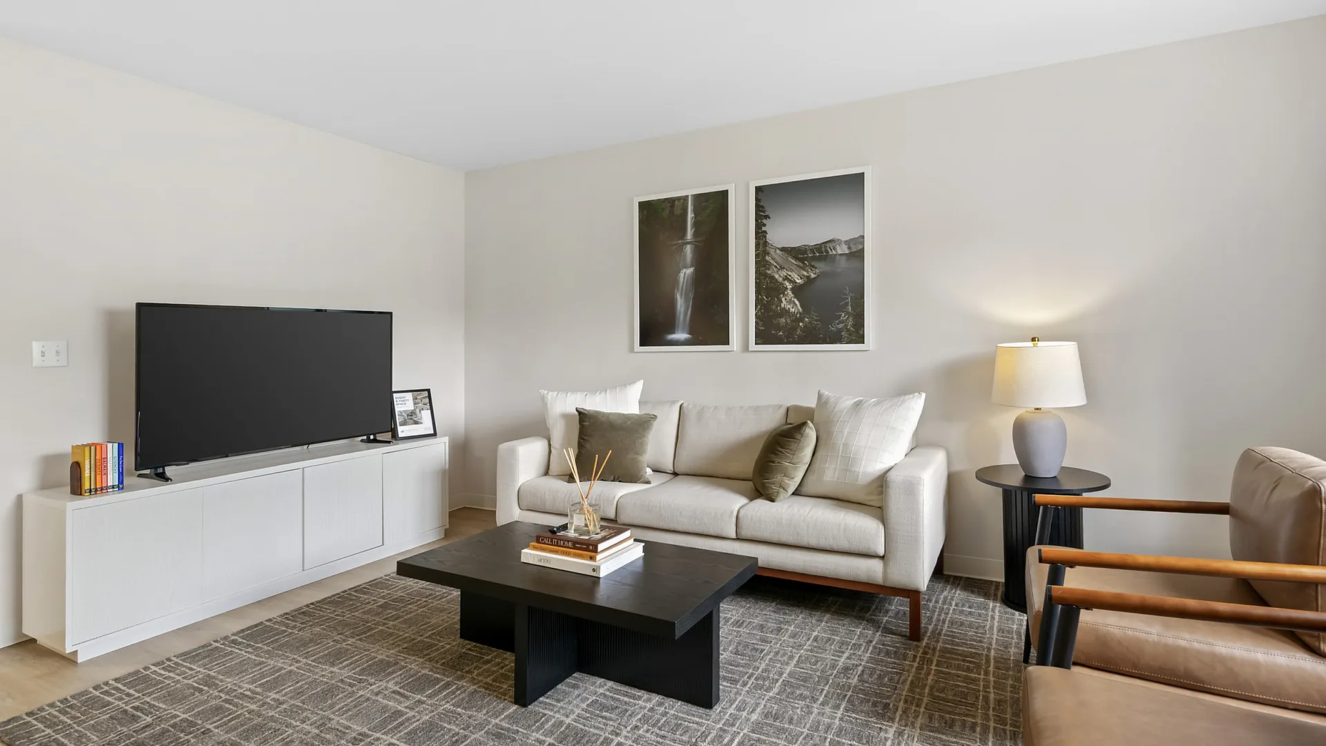 Sleek and modern living room with plush sofa, stylish decor, and cozy lighting for a warm atmosphere.