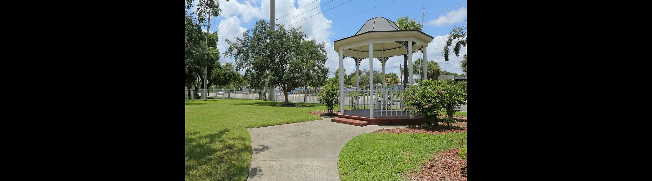 Charming gazebo nestled in a lush garden, offering a serene retreat with picturesque views and vibrant greenery.