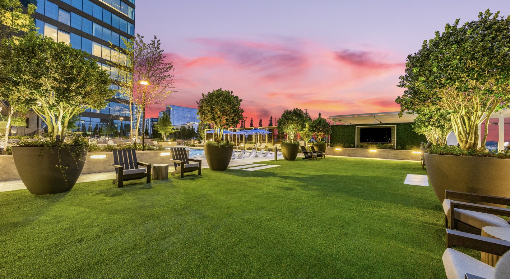Elevated green space featuring lawn games and outdoor lounge areas