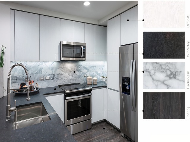Material swatches next to an image of a kitchen with neutral, high-contrast finishes: whitewashed wood cabinets, satin-finish dark gray stone counter, white and gray marbled backsplash, and brown-black wood floors.