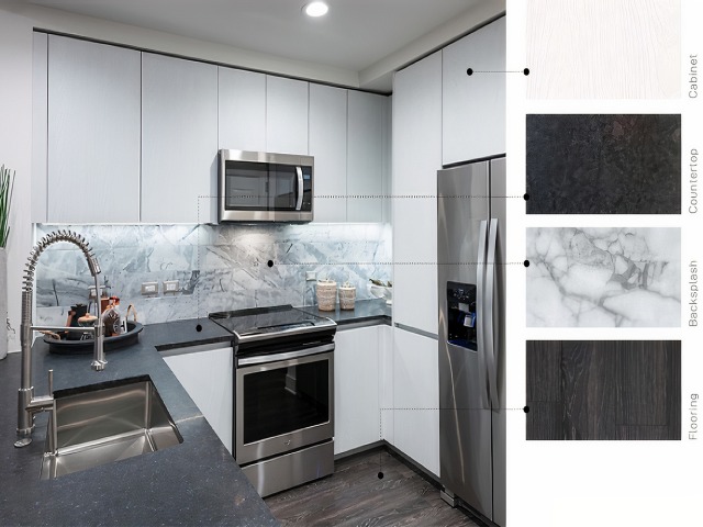 Material swatches next to an image of a kitchen with neutral, high-contrast finishes: whitewashed wood cabinets, satin-finish dark gray stone counter, white and gray marbled backsplash, and brown-black wood floors.
