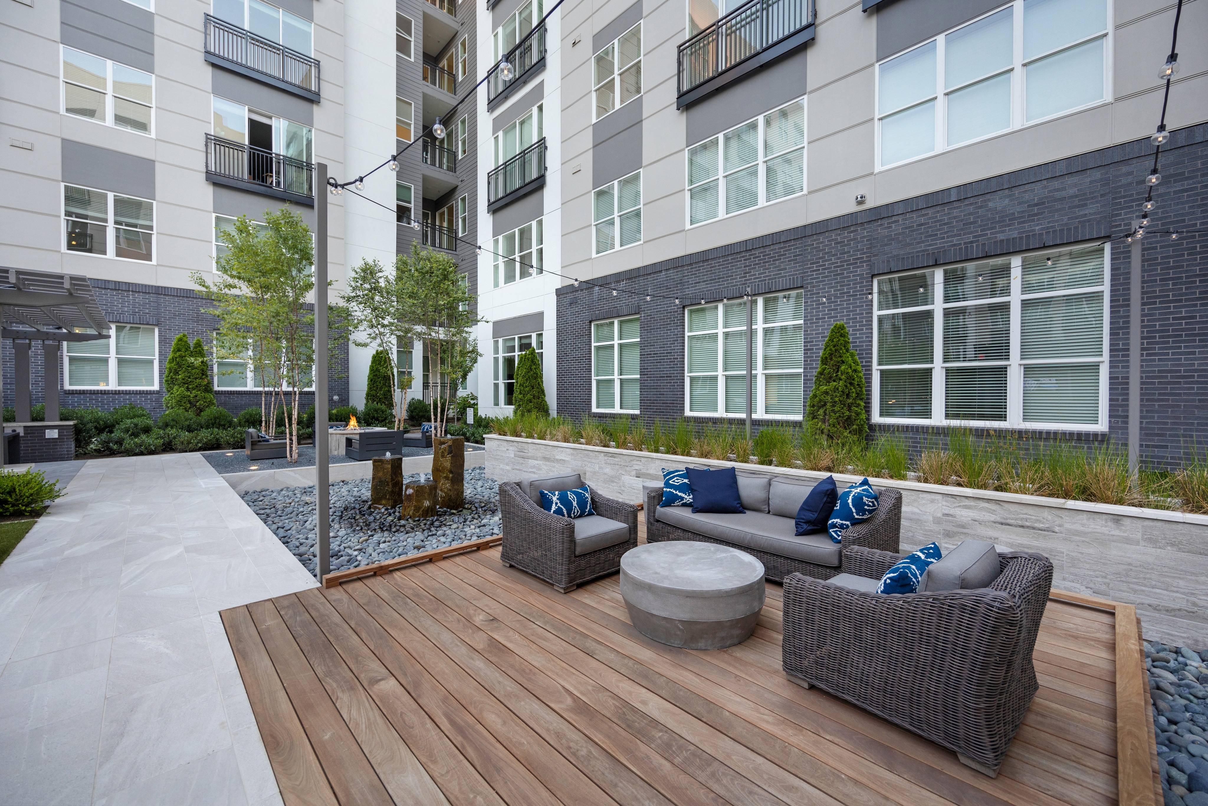Outdoor Fountain Feature, Wood Decks with Lounge Seating, and Outdoor TVs