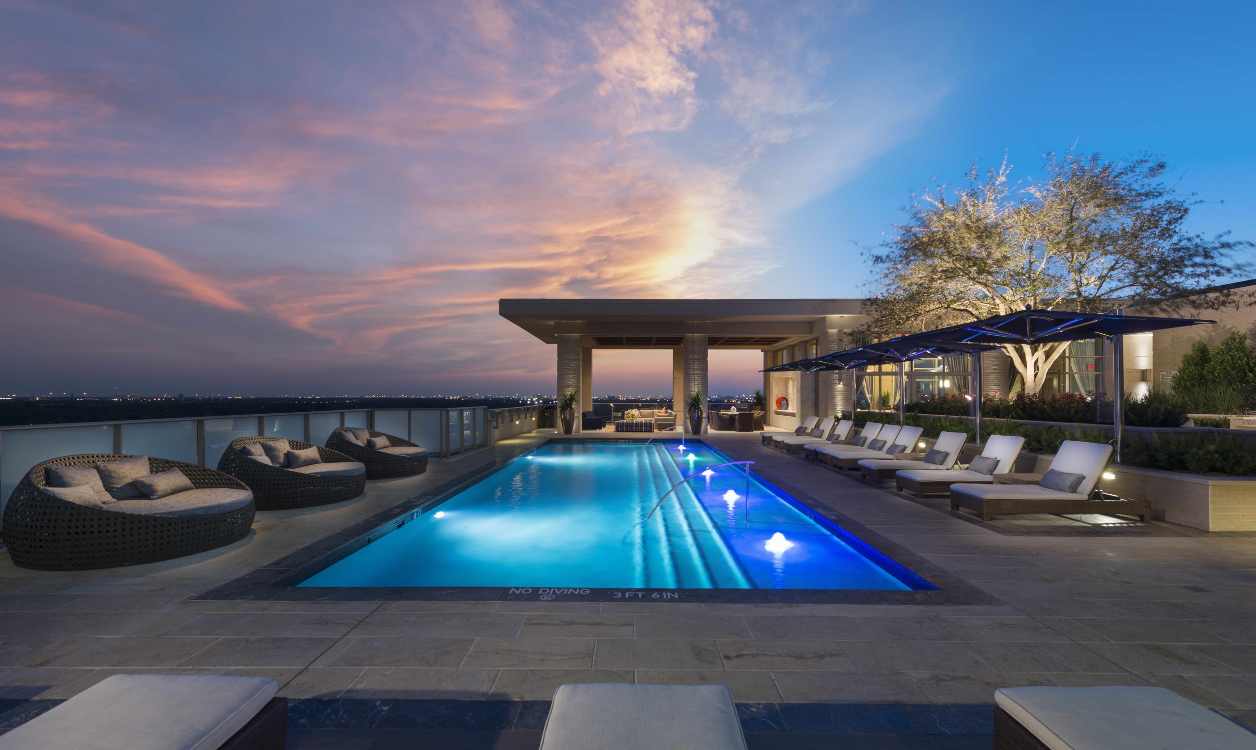 Rooftop pool with sunbeds and poolside cabanas at Hanover Southampton