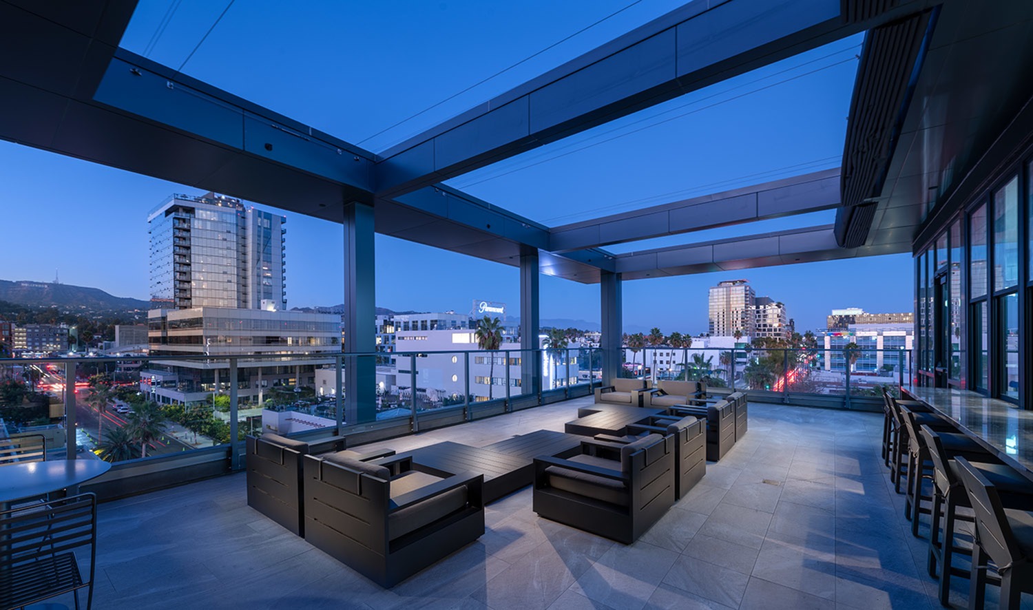 Rooftop skydecks with lounge seating, firepit, outdoor grill, featuring sweeping views of Downtown LA and the Hollywood Sign