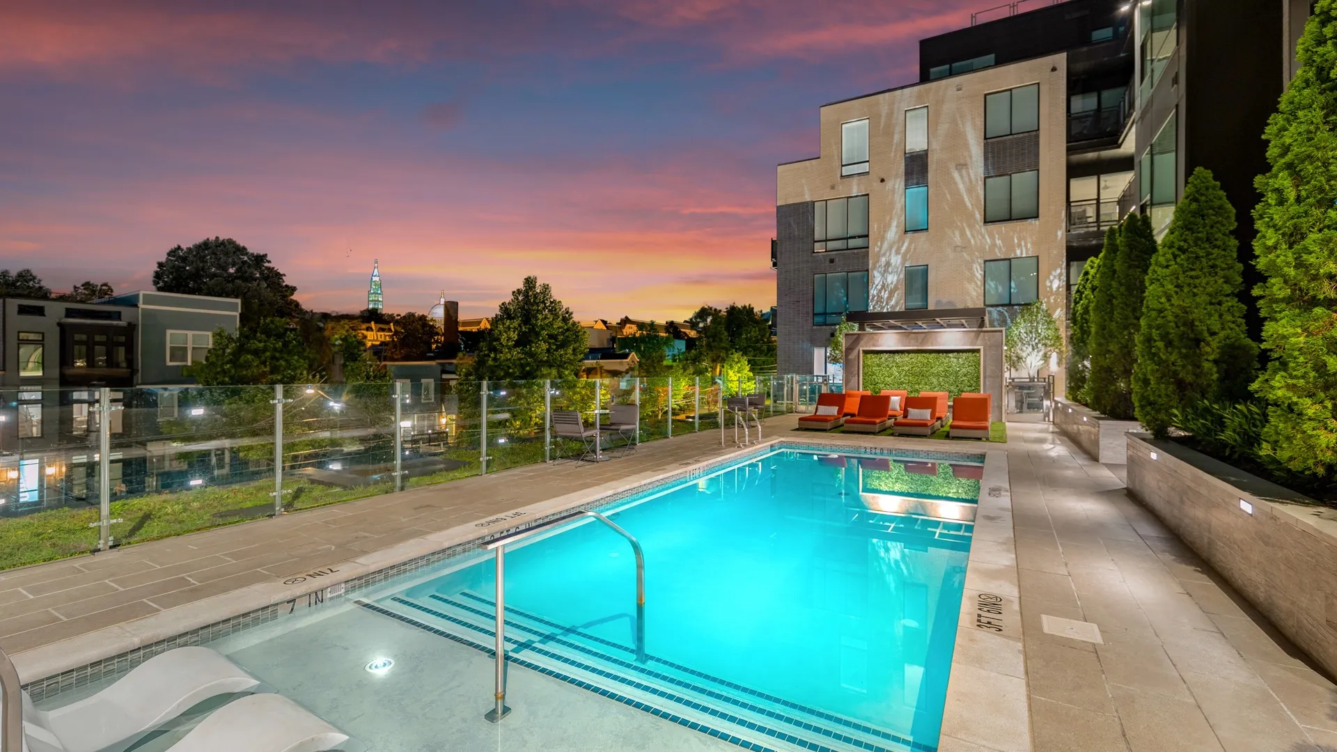 Elevated pool deck featuring cushioned sun loungers, umbrellas, and outdoor seating areas