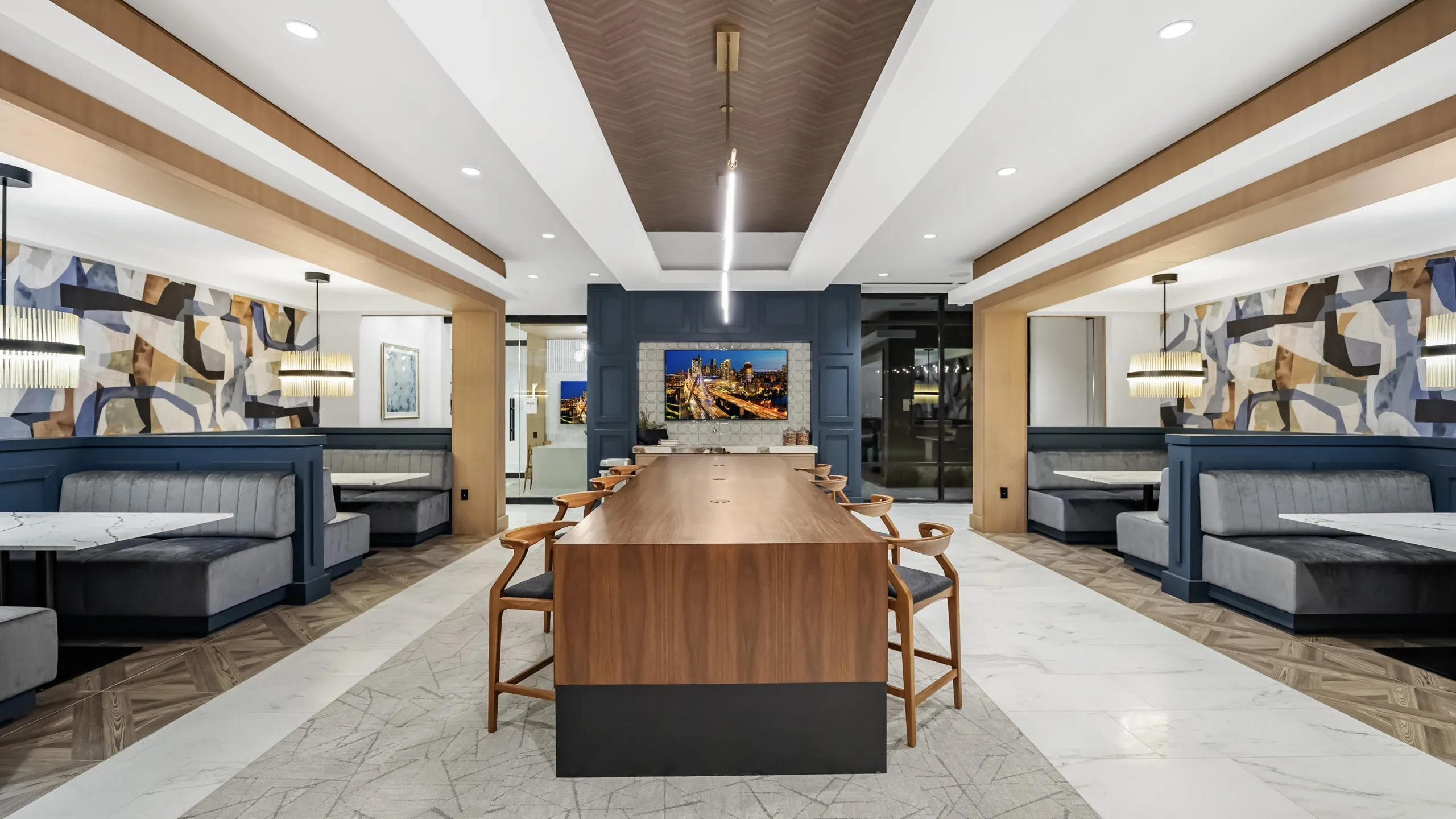 coworking lounge with communal table and 4 booth seating areas