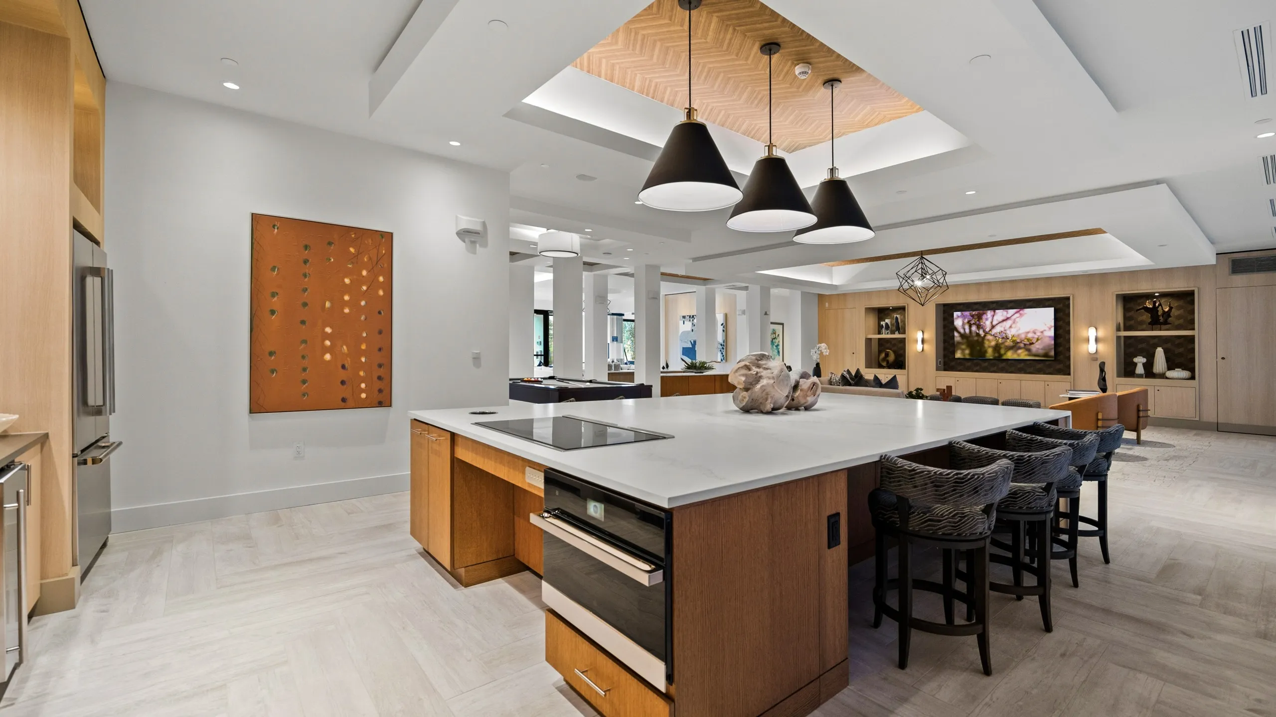 Entertaining kitchen with oven, microwave, fridge, stove top and counter height seating