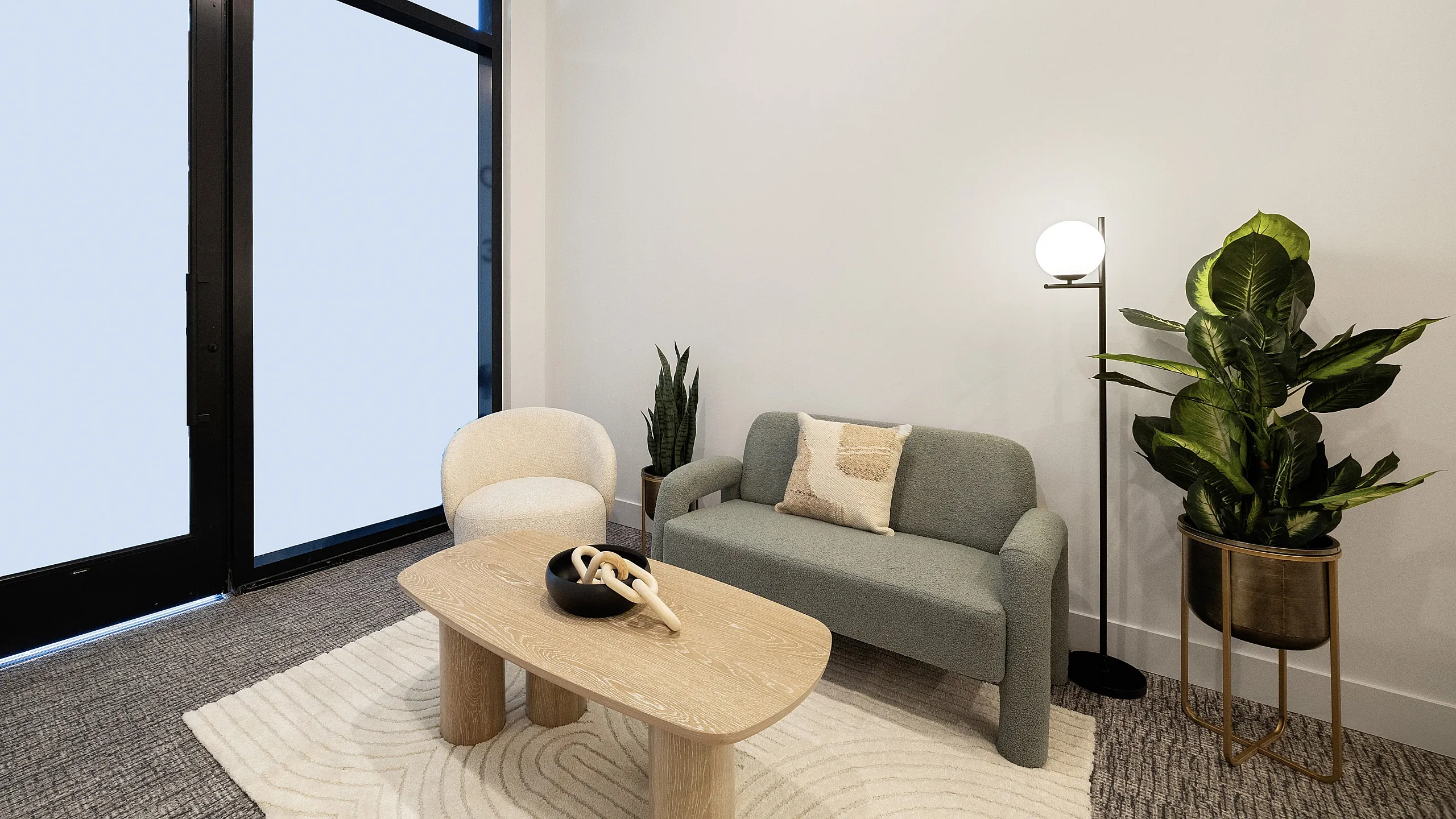 Inviting modern living room with a plush sofa, stylish armchair, wooden coffee table, and lush green plants.