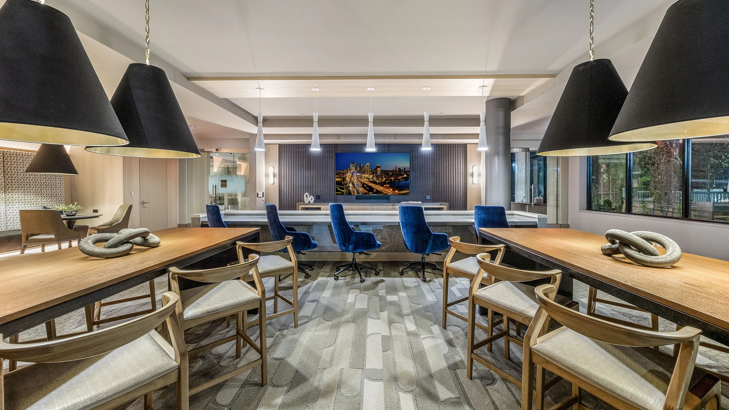 Elegant common area with stylish seating, modern lighting, and large windows providing a serene view outside.