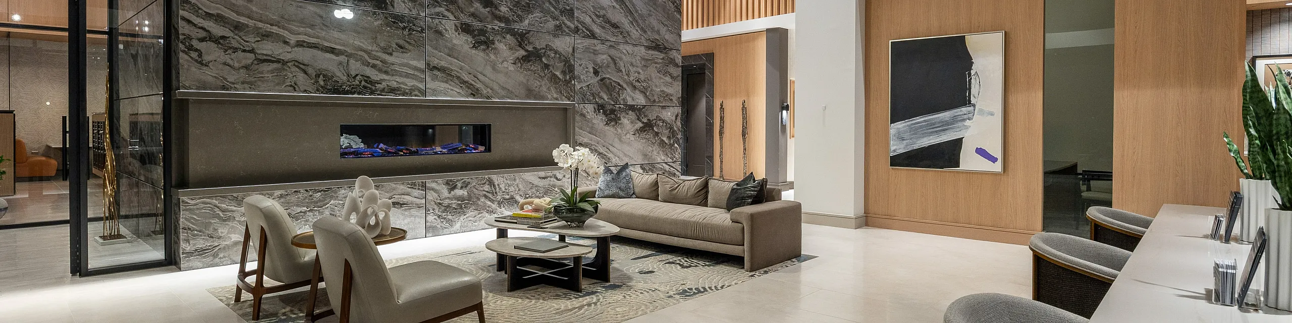 Luxurious modern living room with elegant marble fireplace, high ceilings, and stylish contemporary decor.