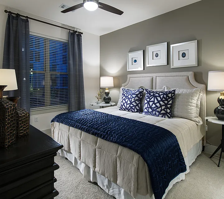 Elegant bedroom with plush bedding, modern decor, and ambient lighting, showcasing a cozy and sophisticated retreat.