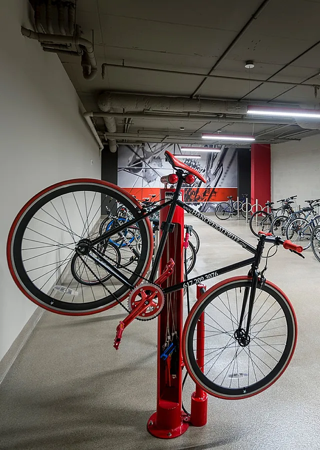 Modern bike storage area with ample space and convenient repair station, ideal for urban living.