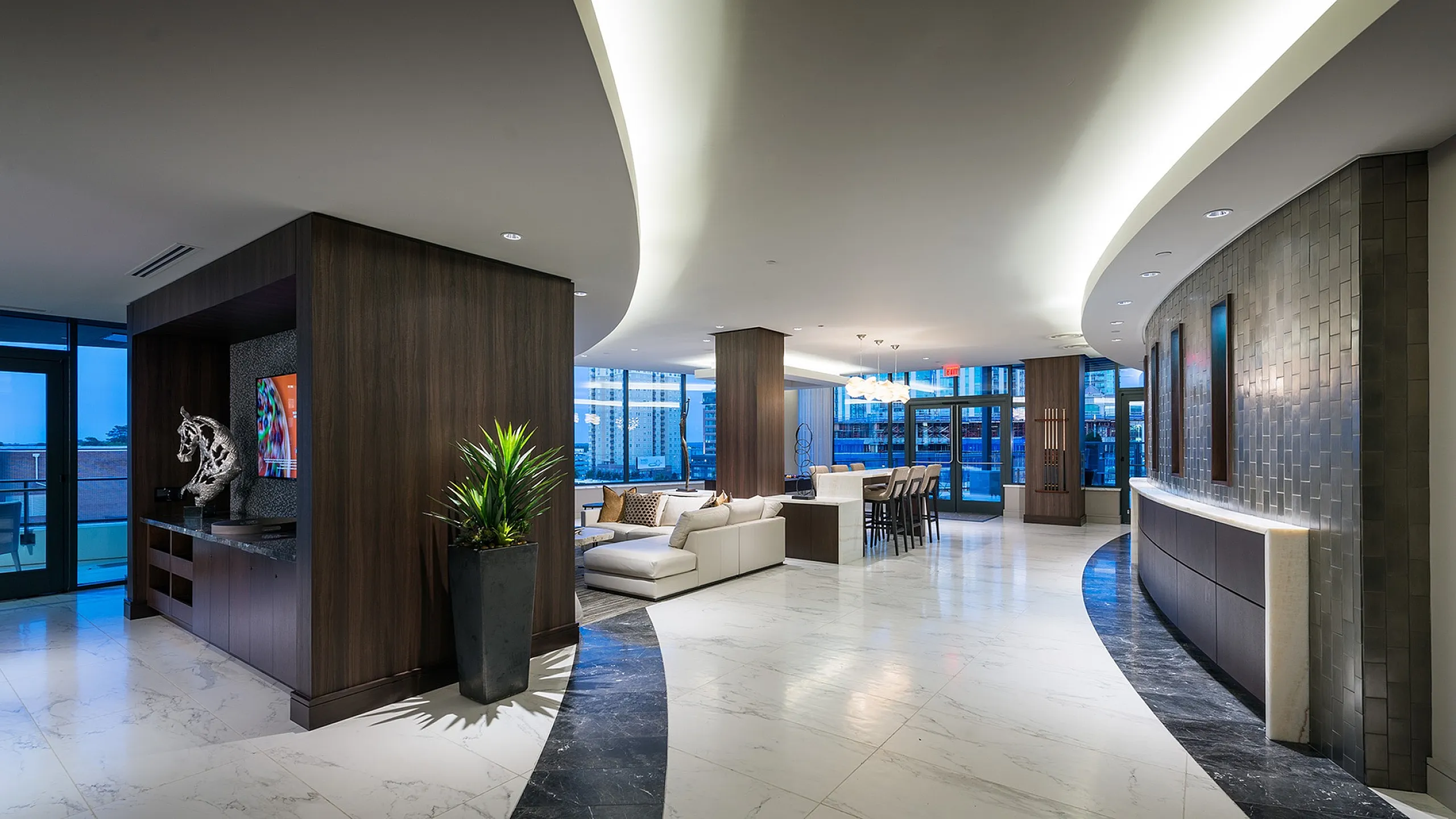 Luxurious modern living space with sleek open-floor design, elegant marble flooring, and panoramic city views.